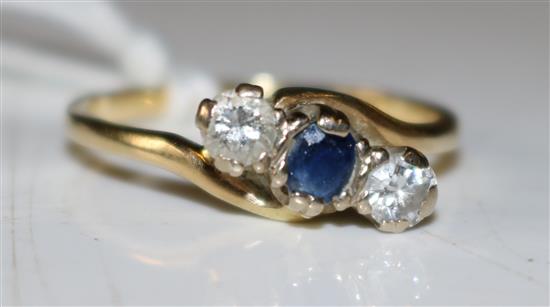 Gold sapphire and diamond crossover ring